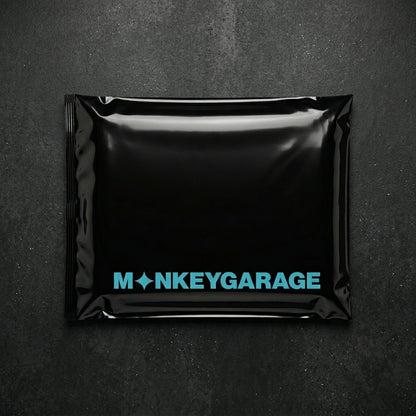 Black packaging with 'MONKEYGARAGE' logo on a dark background inside 1600 gsm greay microfiber cloth 