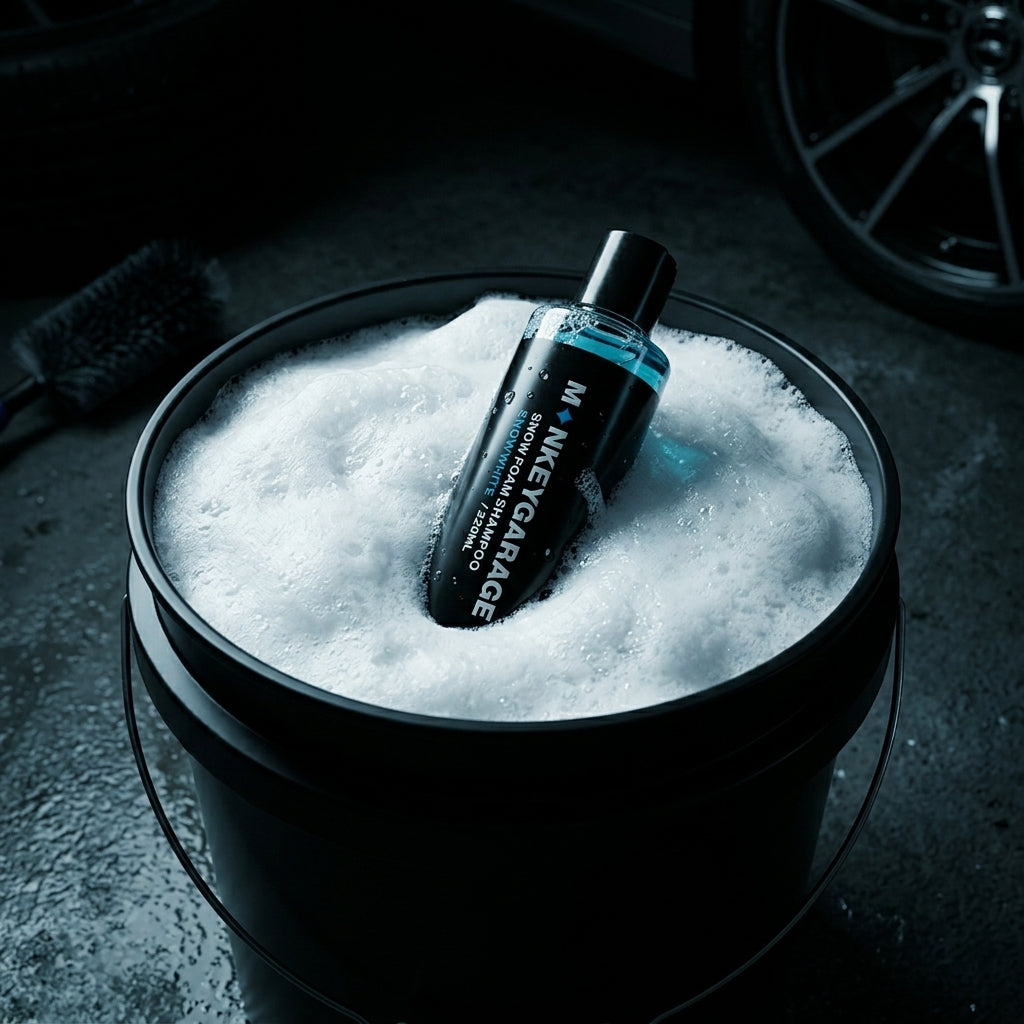 Bottle of Money Garage car wash shampoo in a bucket filled with soapy water.