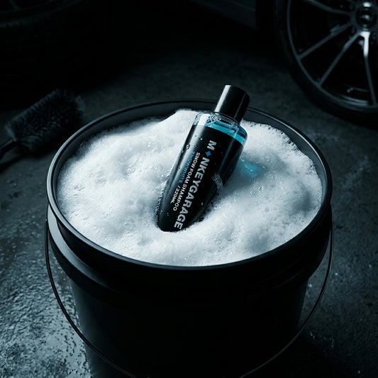 Bottle of Money Garage car wash shampoo in a bucket filled with soapy water.
